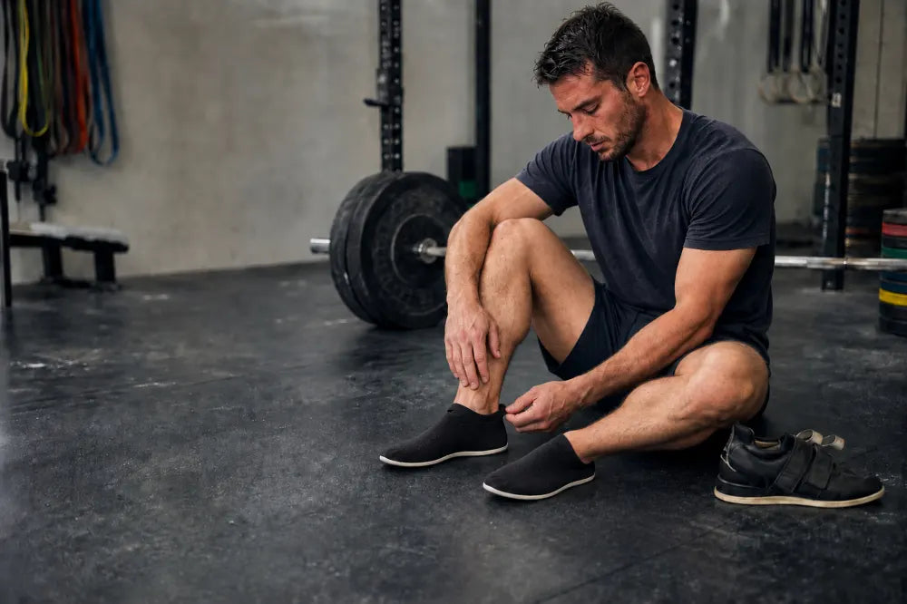 Athlete swapping lifters for black COOPS Low Tops.