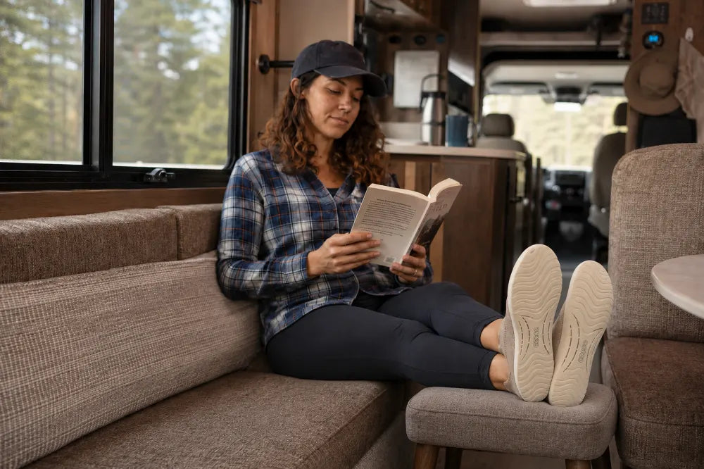 Traveler resting inside an RV in sand COOPS Low Tops.
