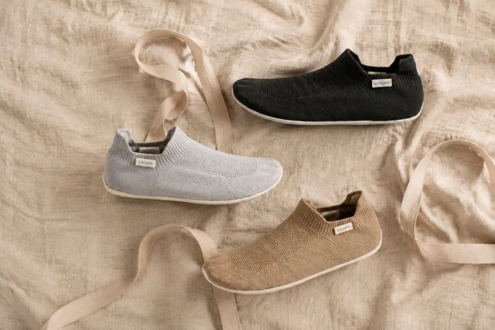 Flat lay of COOPS in black, ash gray and sand.