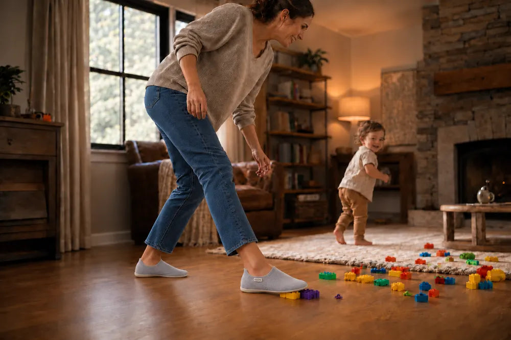 Parent playing with a toddler in ash gray COOPS Low Tops.