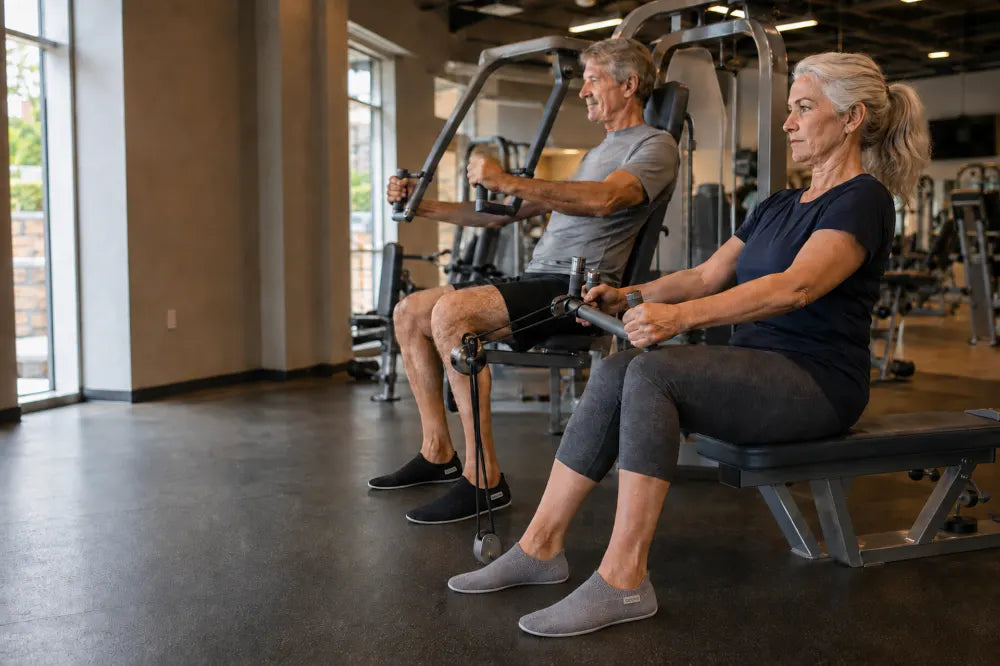 Older couple exercising at a community gym in COOPS Low Tops.