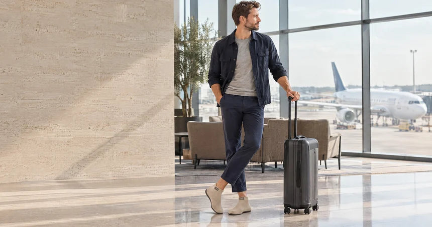 COOPS travel shoes packed beside a carry-on bag