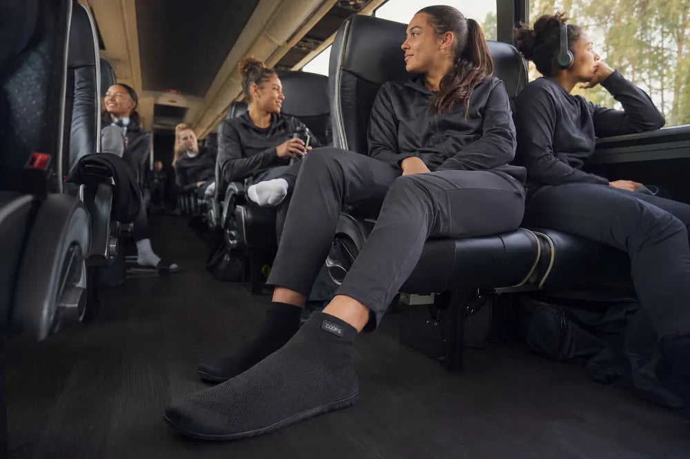 Athletes on a team bus wearing COOPS High Tops.