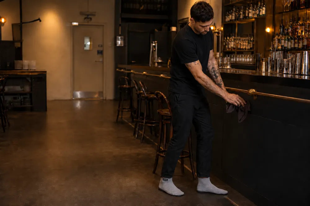 Hospitality worker closing a bar in ash gray COOPS High Tops.