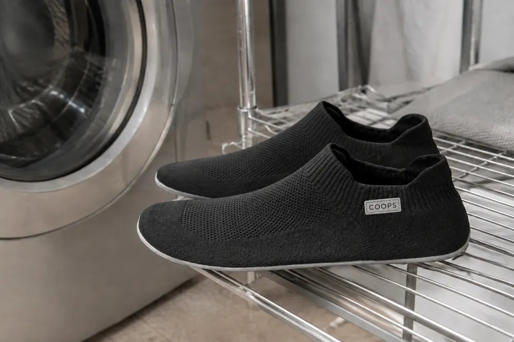 Black COOPS Low Tops air drying after a wash.