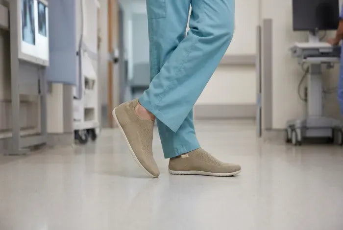 Healthcare worker in scrubs wearing Sand COOPS sock shoes
