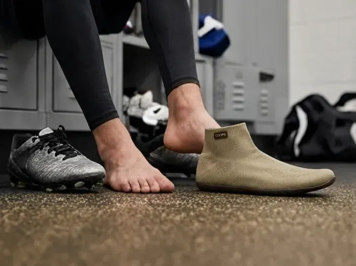 Athlete pulling on Sand COOPS sock shoes after training