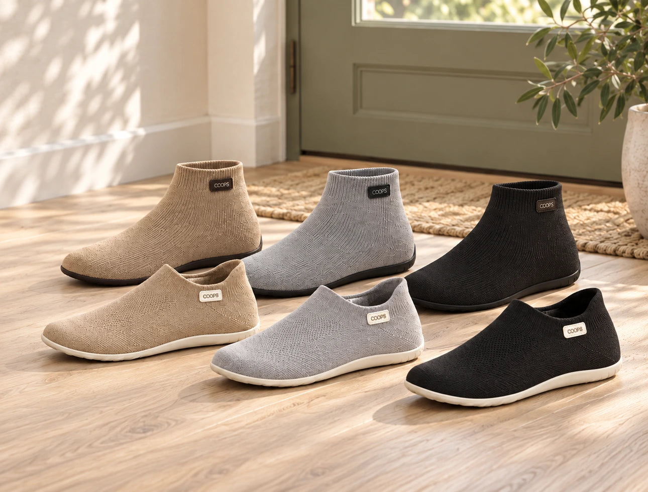 All six COOPS sock shoes, high top and low top in Black, Ash Gray and Sand, lined up by the front door